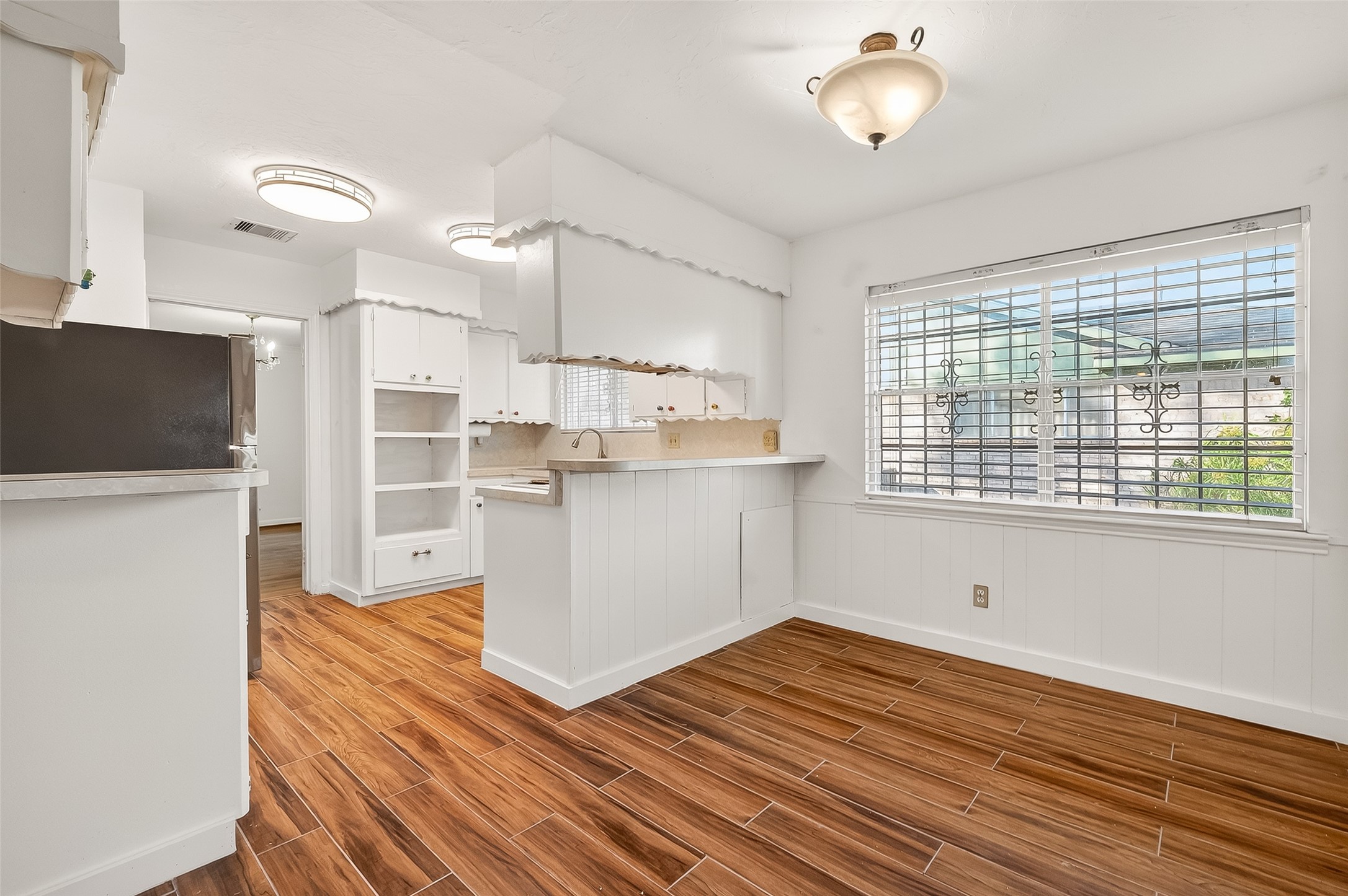 9218 Rowan Lane Houston, TX 77036 - Photo 6 of 32 a view of a kitchen with wooden floor and a sink