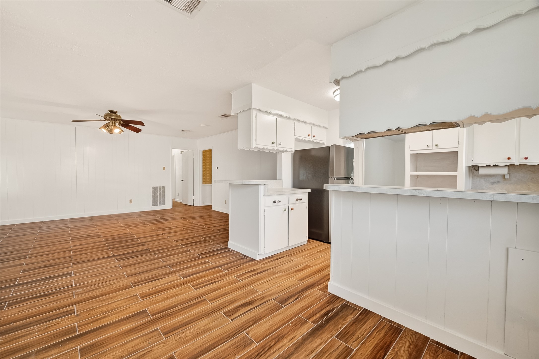 9218 Rowan Lane Houston, TX 77036 - Photo 7 of 32 a view of a kitchen with wooden floor