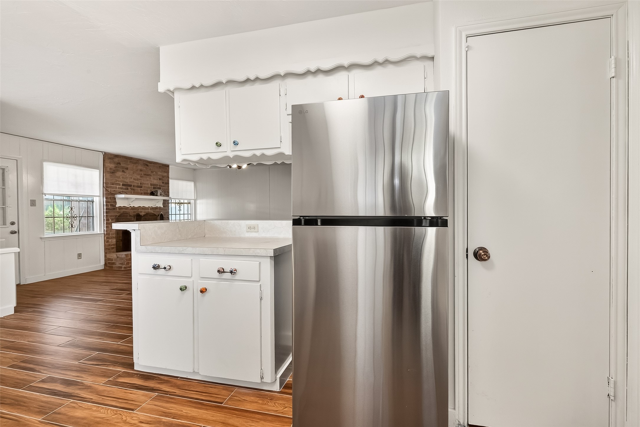 9218 Rowan Lane Houston, TX 77036 - Photo 8 of 32 a kitchen with stainless steel appliances a refrigerator and a wooden floor