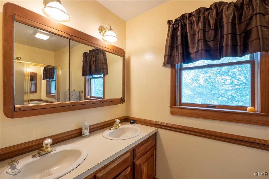 201 Ruth Road Bath, PA 18014 - Photo 15 of 49 a bathroom with a sink and a mirror