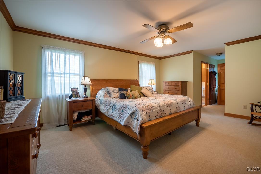 201 Ruth Road Bath, PA 18014 - Photo 17 of 49 a bedroom with a bed and a chandelier