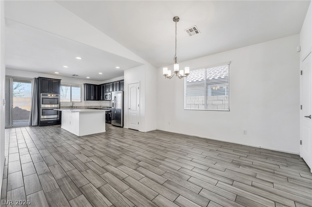 6245 Andover Wood Road Las Vegas, NV 89113 - Photo 5 of 37 An open concept design, this kitchen and dining area provides seamless flow with durable tile flooring.