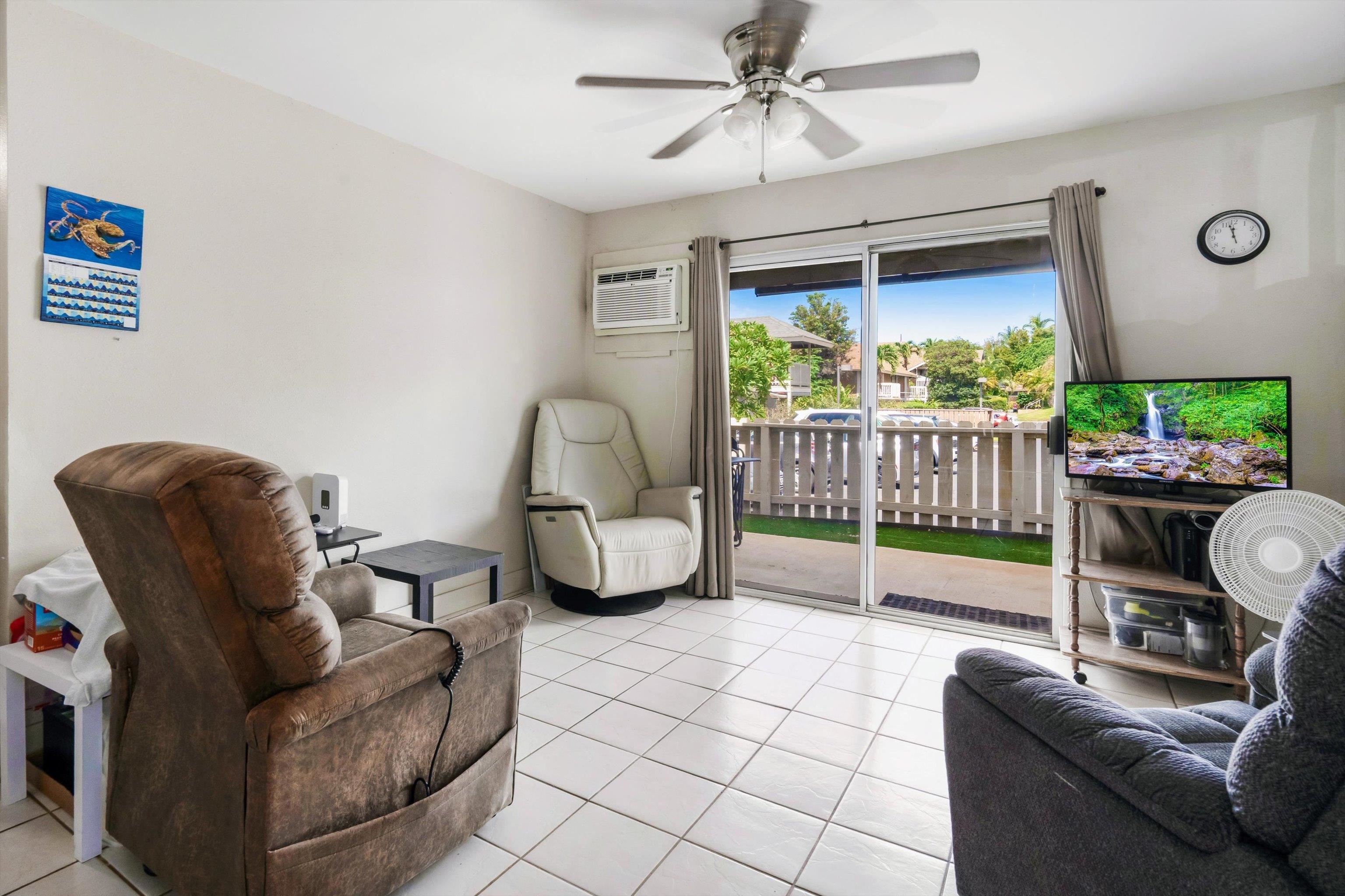 140 Uwapo Road, Unit 19105 Kihei, HI 96753 - Photo 12 of 42 a living room with furniture and a flat screen tv
