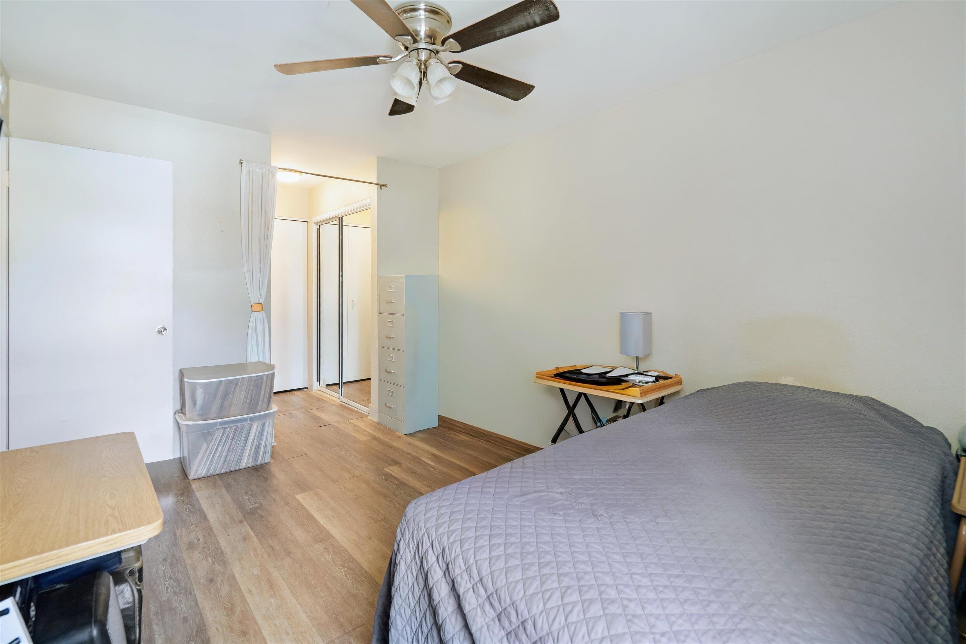 140 Uwapo Road, Unit 19105 Kihei, HI 96753 - Photo 17 of 42 a bedroom with a bed and a table in it