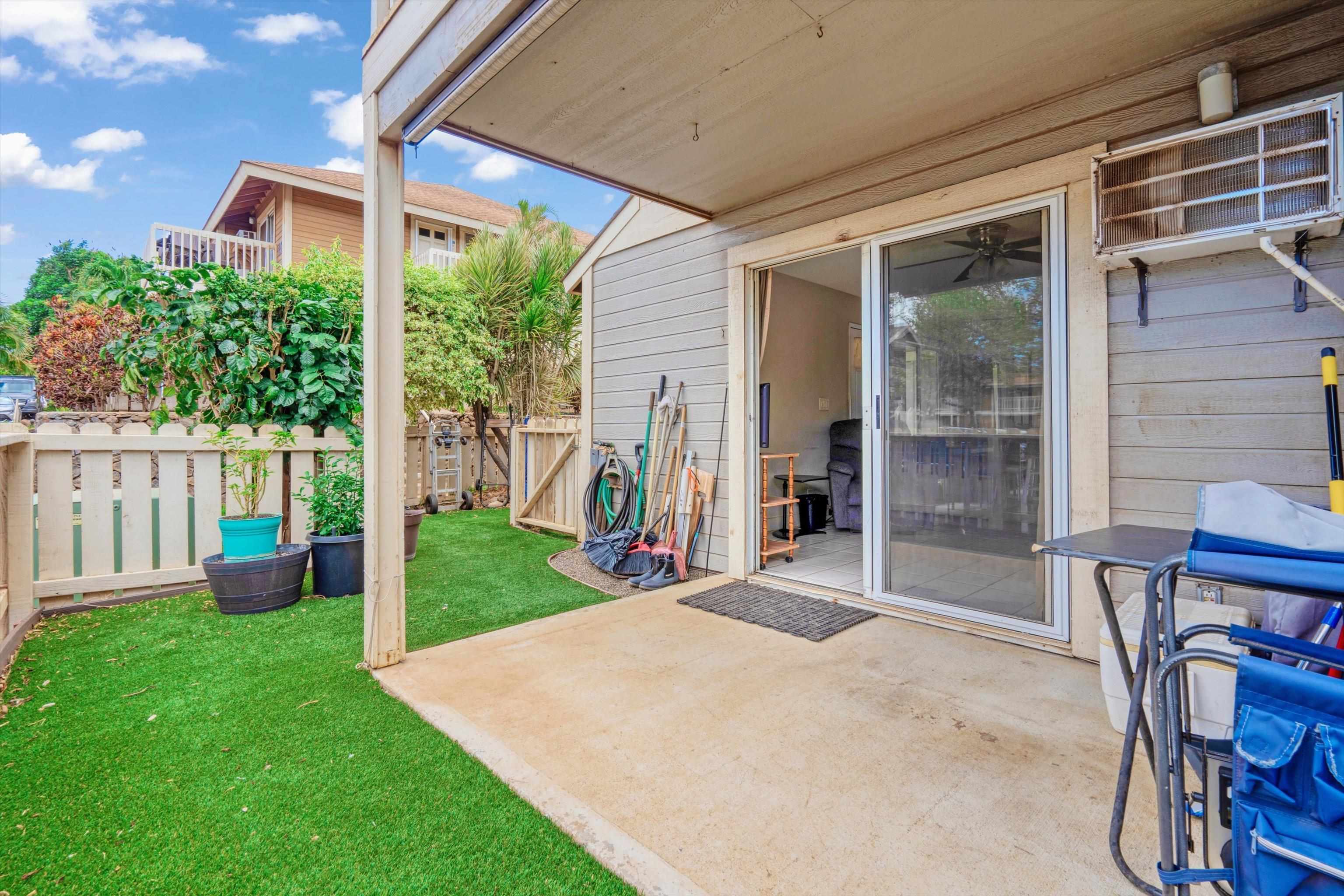 140 Uwapo Road, Unit 19105 Kihei, HI 96753 - Photo 22 of 42 a view of a backyard with table and chairs and a barbeque
