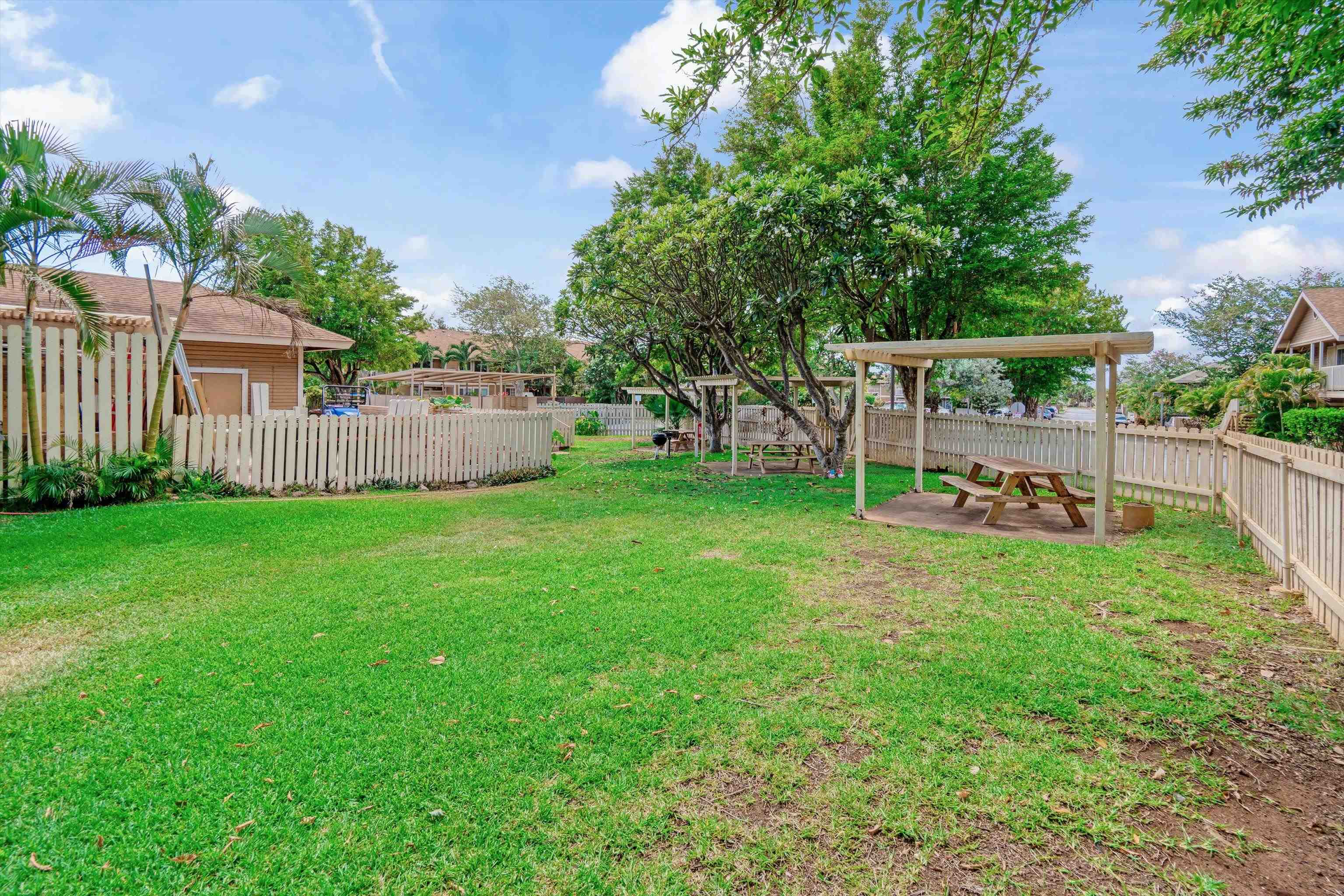 140 Uwapo Road, Unit 19105 Kihei, HI 96753 - Photo 33 of 42 a view of a house with backyard and a tree