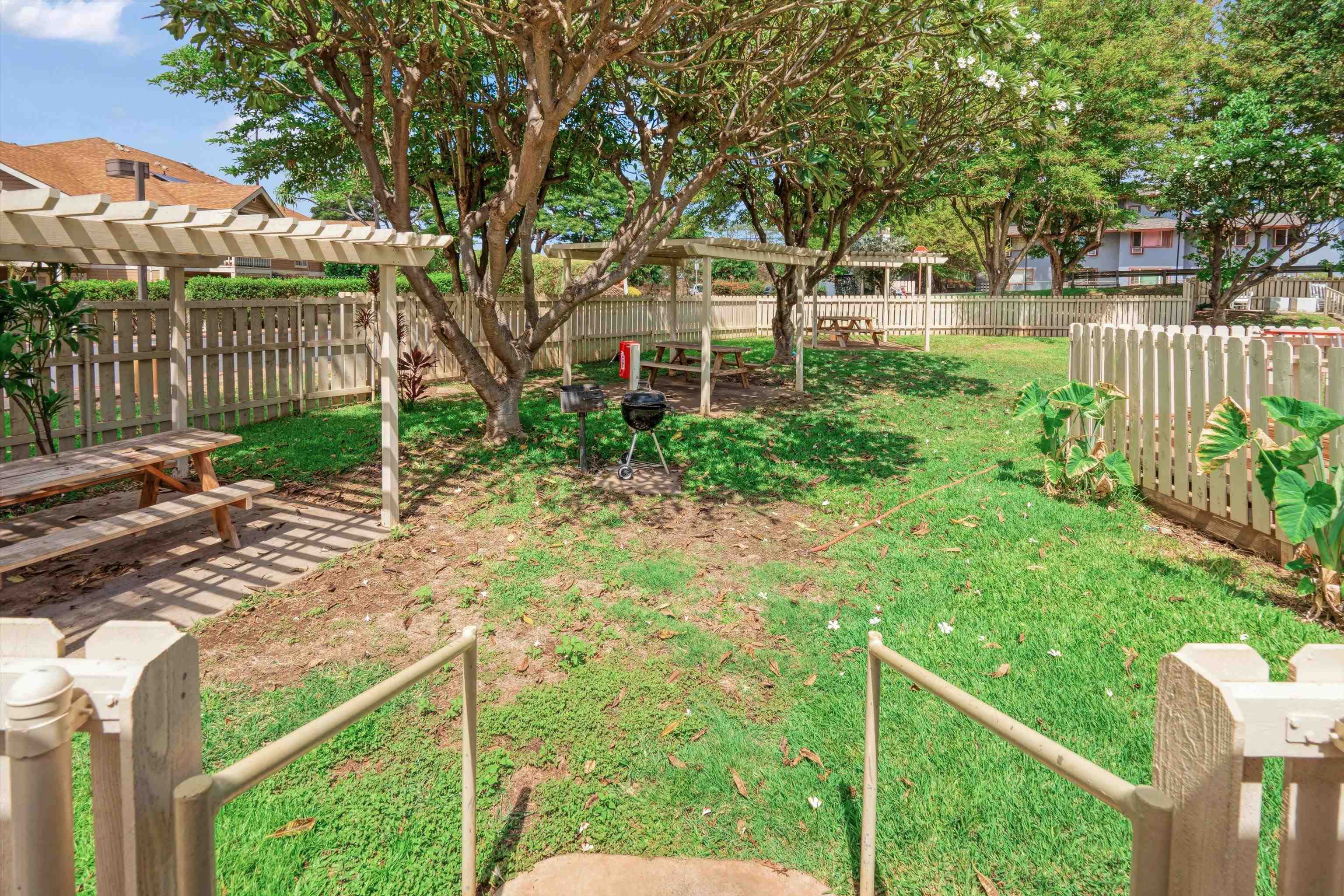 140 Uwapo Road, Unit 19105 Kihei, HI 96753 - Photo 35 of 42 a view of a backyard with wooden fence