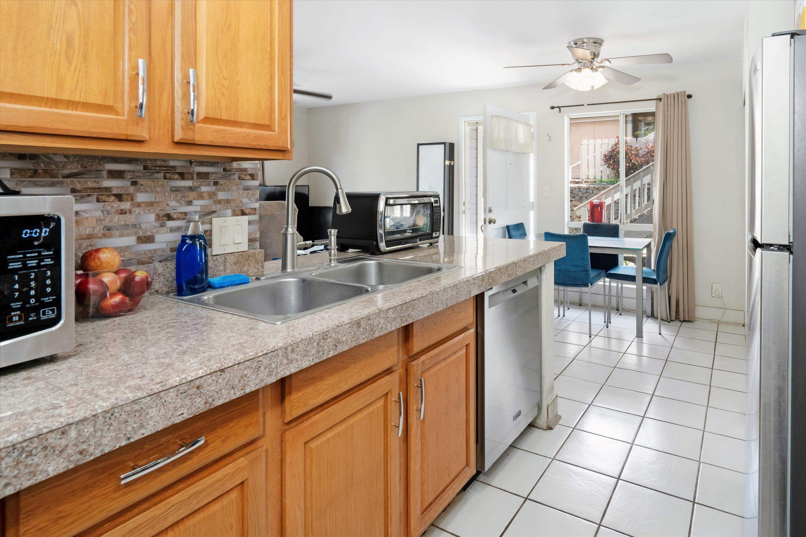 140 Uwapo Road, Unit 19105 Kihei, HI 96753 - Photo 4 of 42 a kitchen with stainless steel appliances granite countertop a sink and cabinets