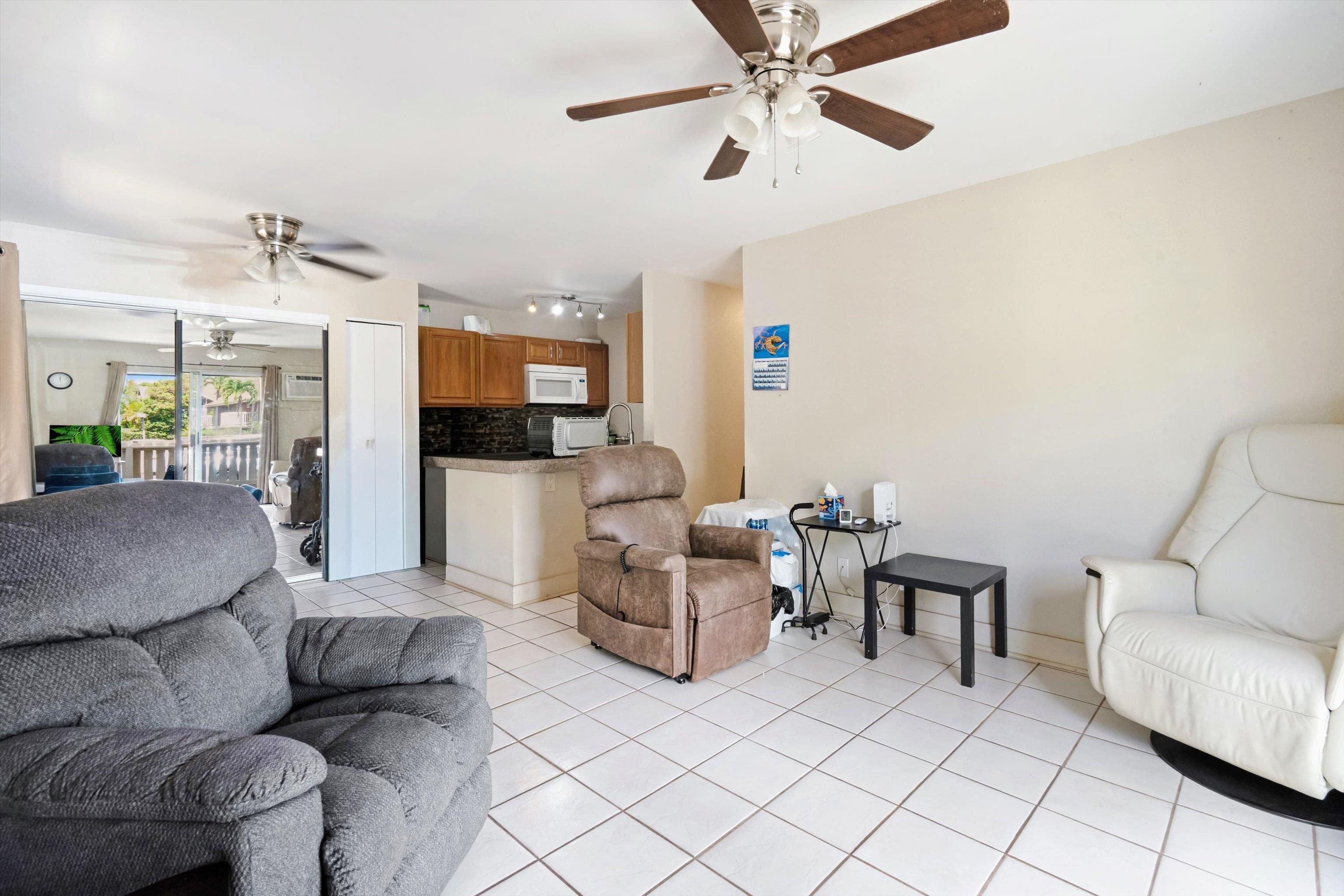140 Uwapo Road, Unit 19105 Kihei, HI 96753 - Photo 10 of 42 a living room with furniture and a chandelier
