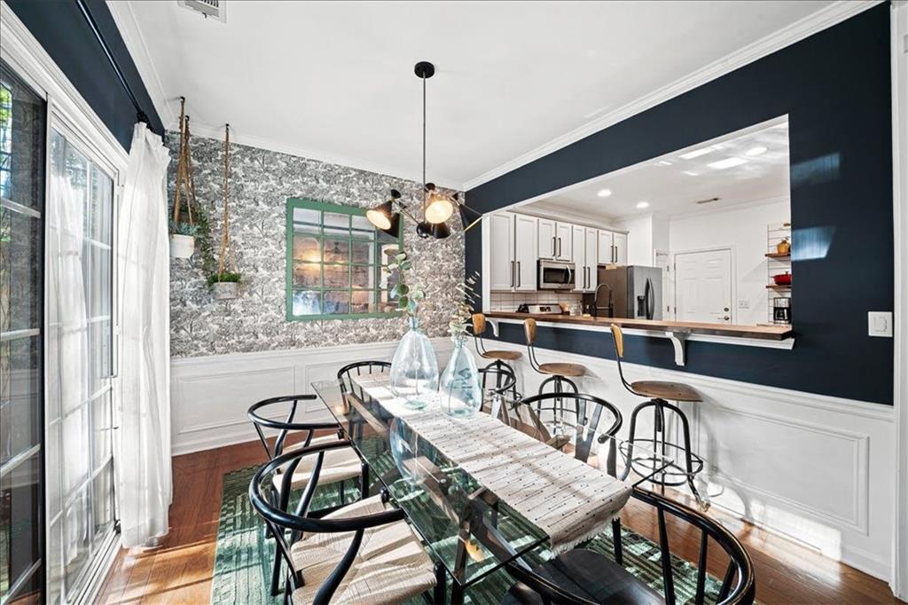 5800 Oakdale Road Southeast, Unit 150 Mableton, GA 30126 - Photo 11 of 36 a dining room with furniture a chandelier and wooden floor