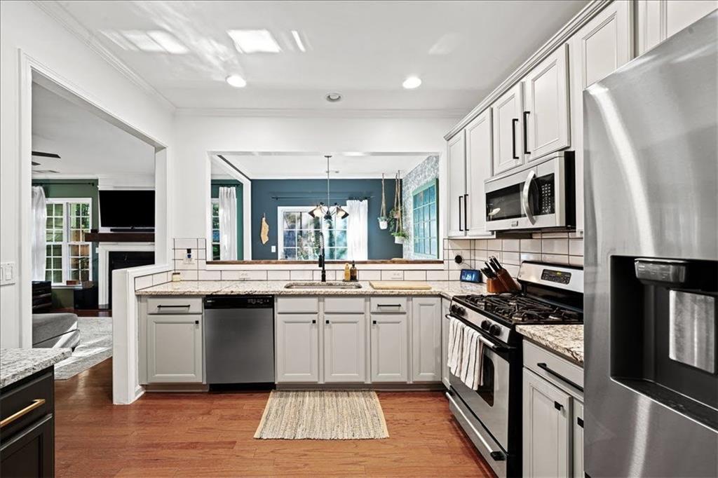 5800 Oakdale Road Southeast, Unit 150 Mableton, GA 30126 - Photo 12 of 36 a kitchen with stainless steel appliances a stove sink microwave and cabinets