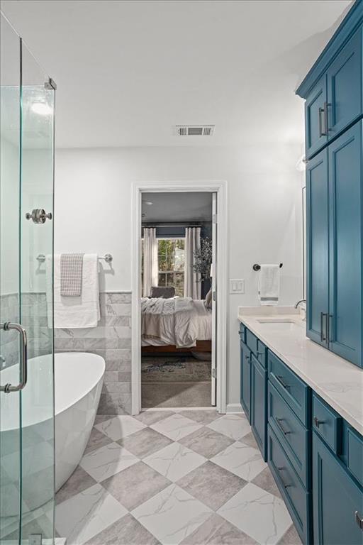 5800 Oakdale Road Southeast, Unit 150 Mableton, GA 30126 - Photo 18 of 36 a spacious bathroom with a tub sink and mirror