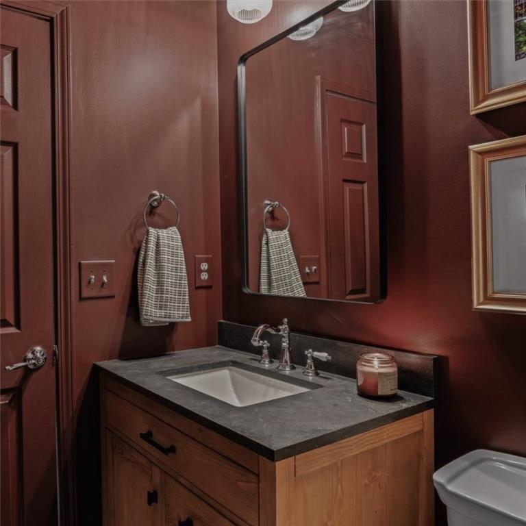 5800 Oakdale Road Southeast, Unit 150 Mableton, GA 30126 - Photo 27 of 36 a bathroom with a granite countertop sink and a mirror