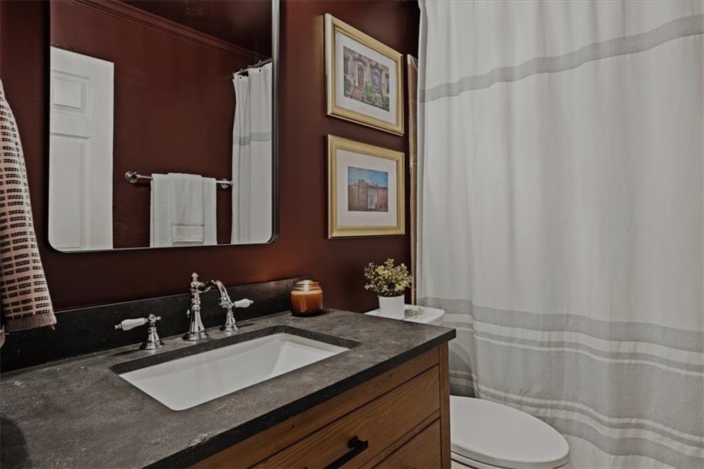 5800 Oakdale Road Southeast, Unit 150 Mableton, GA 30126 - Photo 28 of 36 a bathroom with a granite countertop sink toilet and mirror