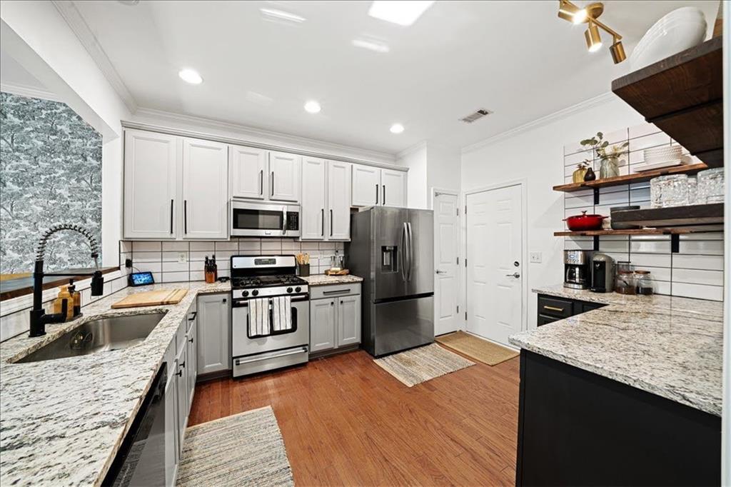 5800 Oakdale Road Southeast, Unit 150 Mableton, GA 30126 - Photo 3 of 36 a kitchen with stainless steel appliances granite countertop a sink dishwasher stove refrigerator and cabinets