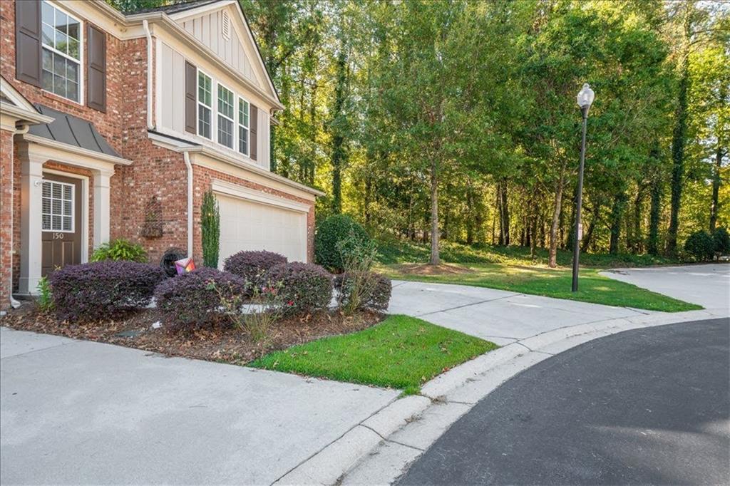 5800 Oakdale Road Southeast, Unit 150 Mableton, GA 30126 - Photo 36 of 36 a front view of a house with garden and trees