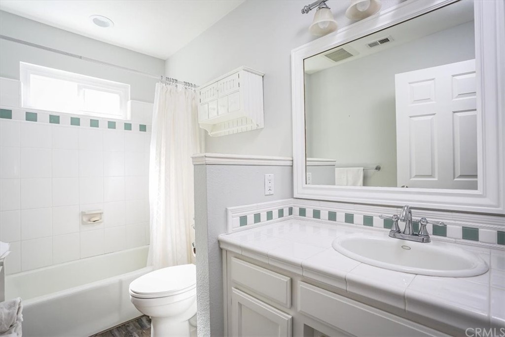 1585 Donelson Place Templeton, CA 93465 - Photo 17 of 37 a bathroom with a granite countertop sink mirror vanity and toilet