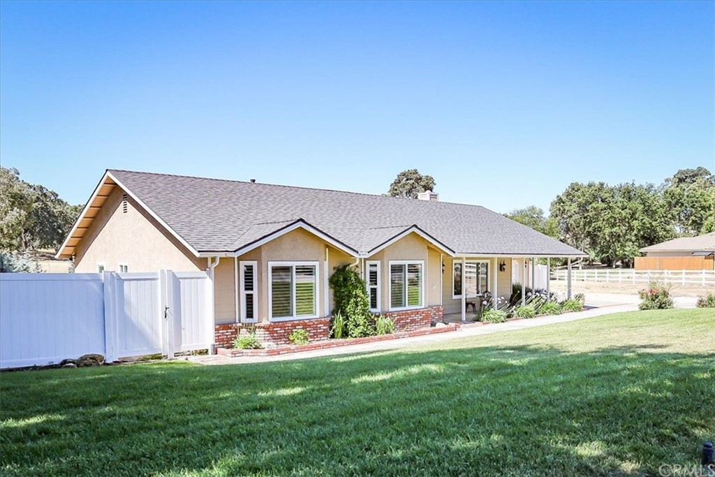 1585 Donelson Place Templeton, CA 93465 - Photo 2 of 37 a front view of a house with a garden and yard