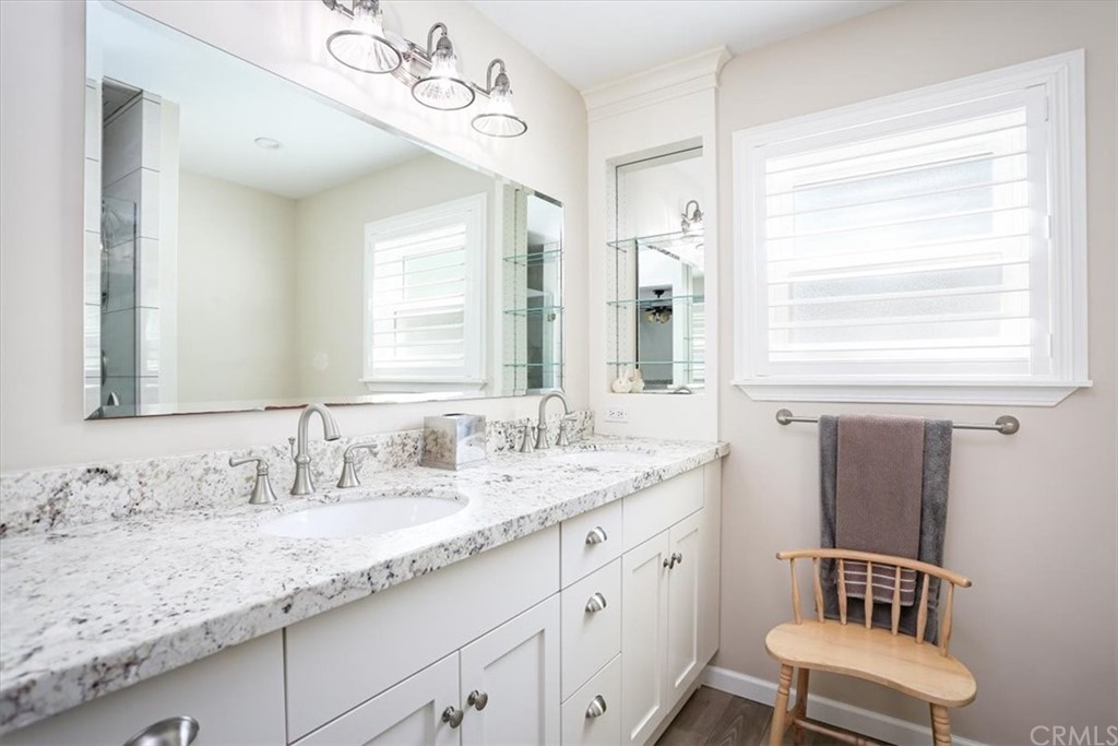 1585 Donelson Place Templeton, CA 93465 - Photo 21 of 37 a bathroom with a granite countertop sink a toilet and mirror