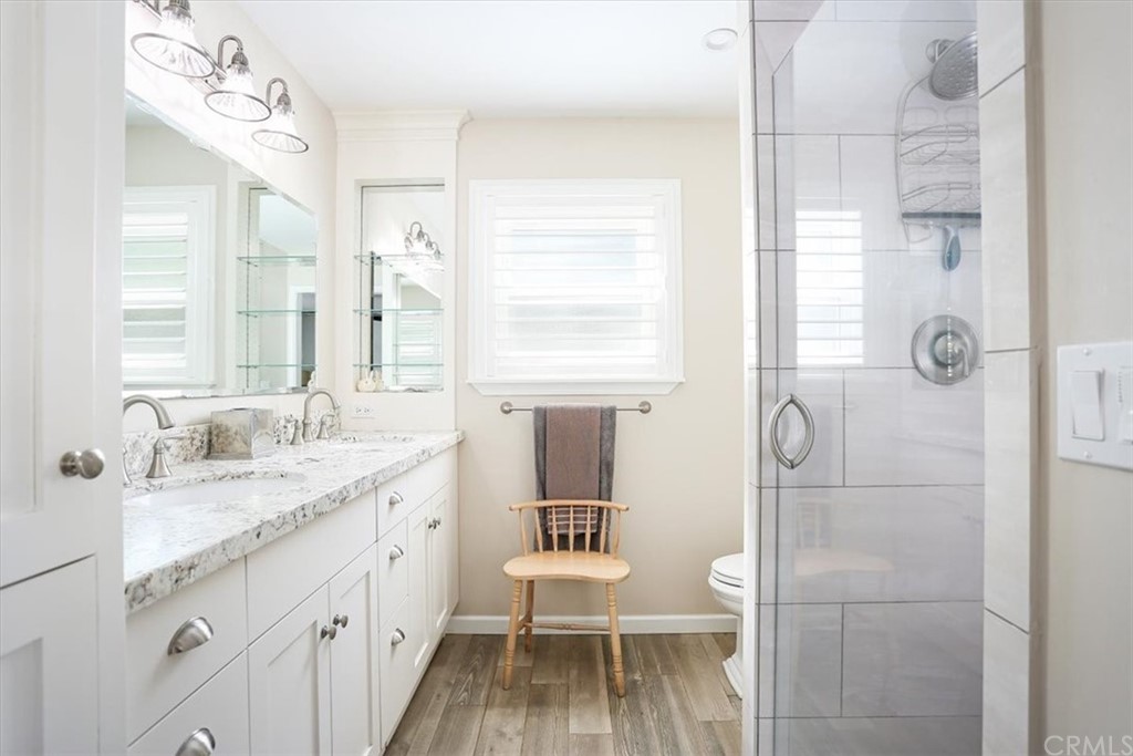 1585 Donelson Place Templeton, CA 93465 - Photo 22 of 37 a bathroom with a granite countertop sink a toilet a mirror and shower