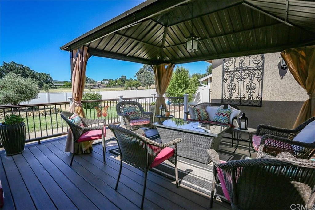 1585 Donelson Place Templeton, CA 93465 - Photo 25 of 37 a patio with wooden floor a yard a table and chairs