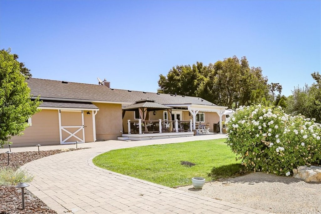 1585 Donelson Place Templeton, CA 93465 - Photo 32 of 37 a front view of a house with a yard table and chairs