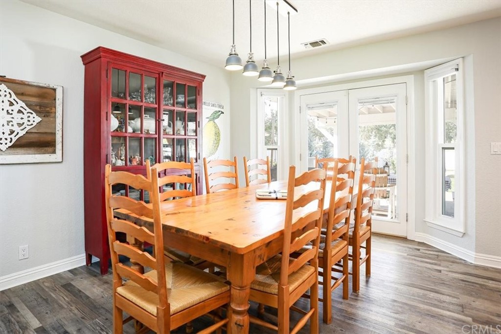 1585 Donelson Place Templeton, CA 93465 - Photo 7 of 37 a dining room with wooden floor a chandelier a wooden table and chairs
