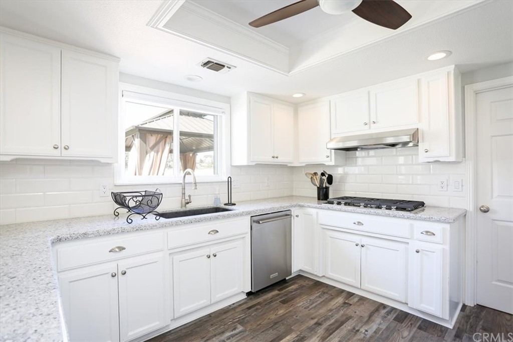 1585 Donelson Place Templeton, CA 93465 - Photo 10 of 37 a kitchen with a sink dishwasher and white cabinets with wooden floor