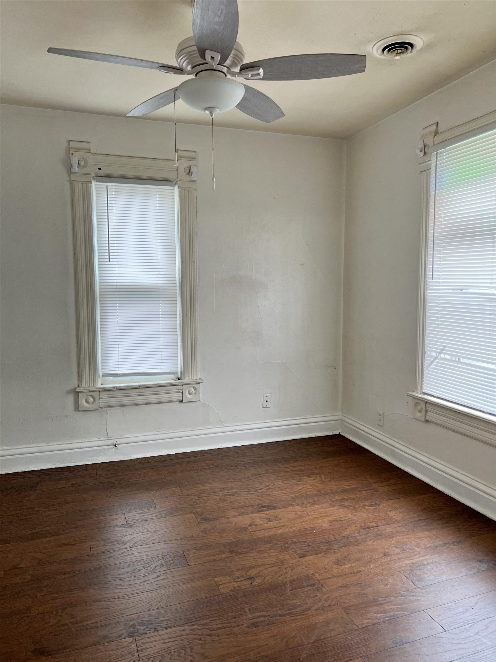 417 9th Street Rockford, IL 61104 - Photo 11 of 11 an empty room with wooden floor cabinet and windows