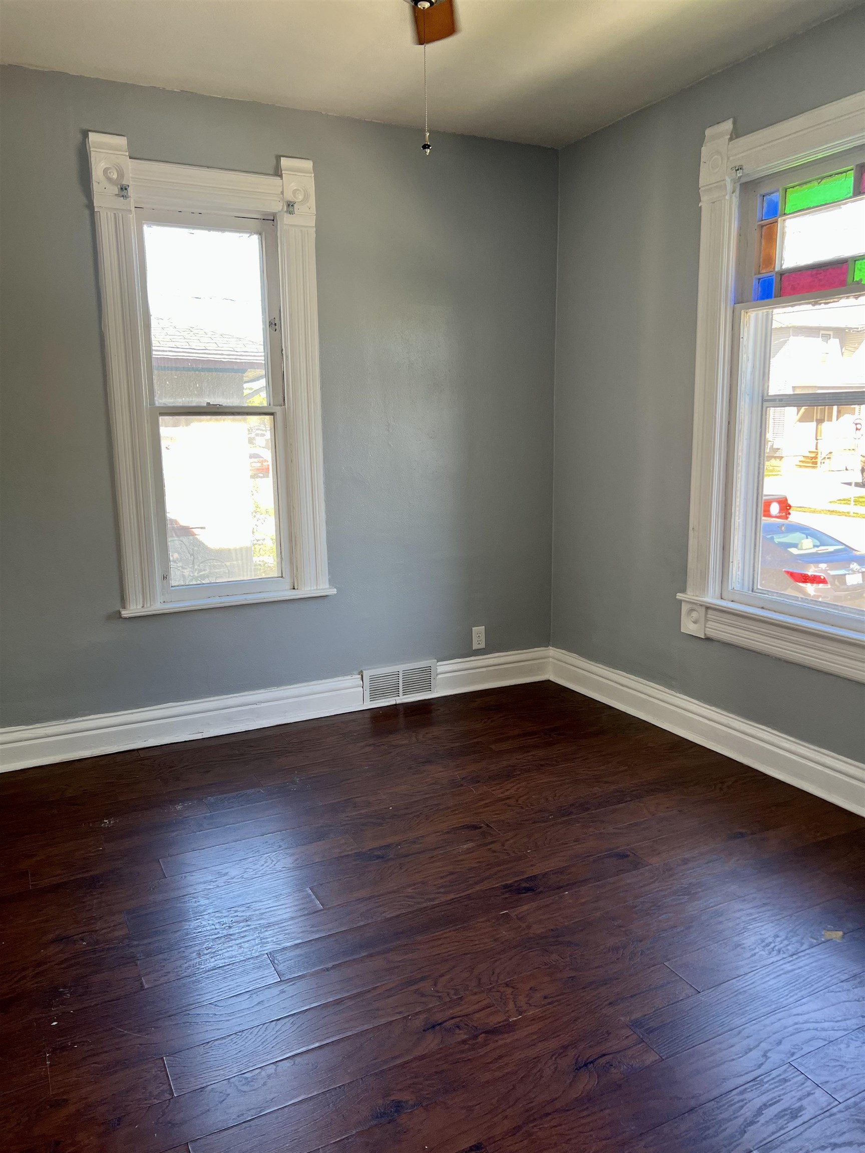 417 9th Street Rockford, IL 61104 - Photo 4 of 11 an empty room with wooden floor and windows