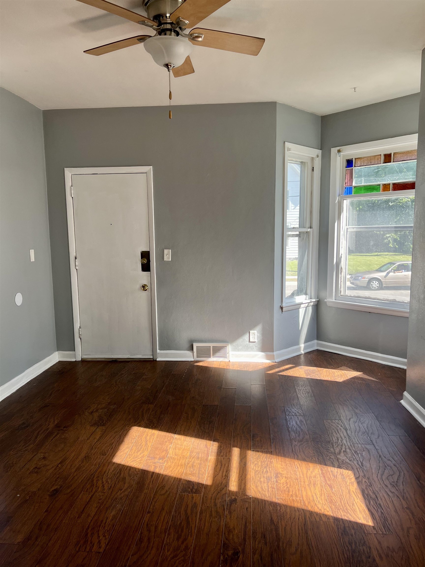 417 9th Street Rockford, IL 61104 - Photo 6 of 11 an empty room with wooden floor and windows