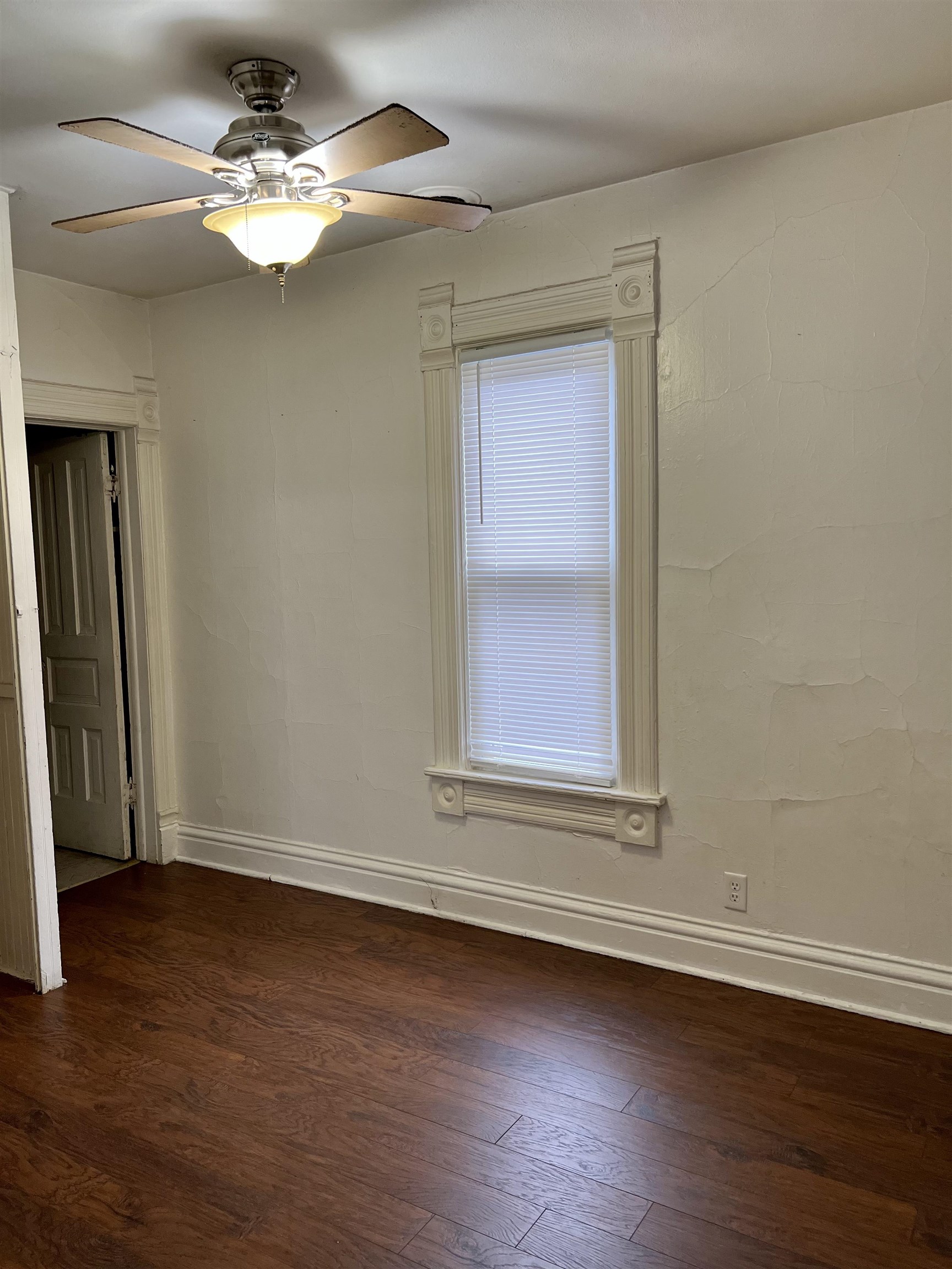 417 9th Street Rockford, IL 61104 - Photo 7 of 11 a view of a livingroom with wooden floor and a ceiling fan