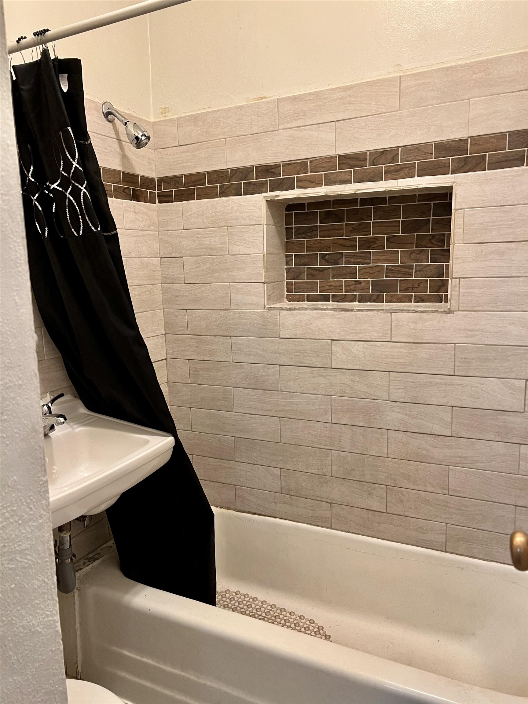 417 9th Street Rockford, IL 61104 - Photo 8 of 11 a bathroom with a bathtub and a shower