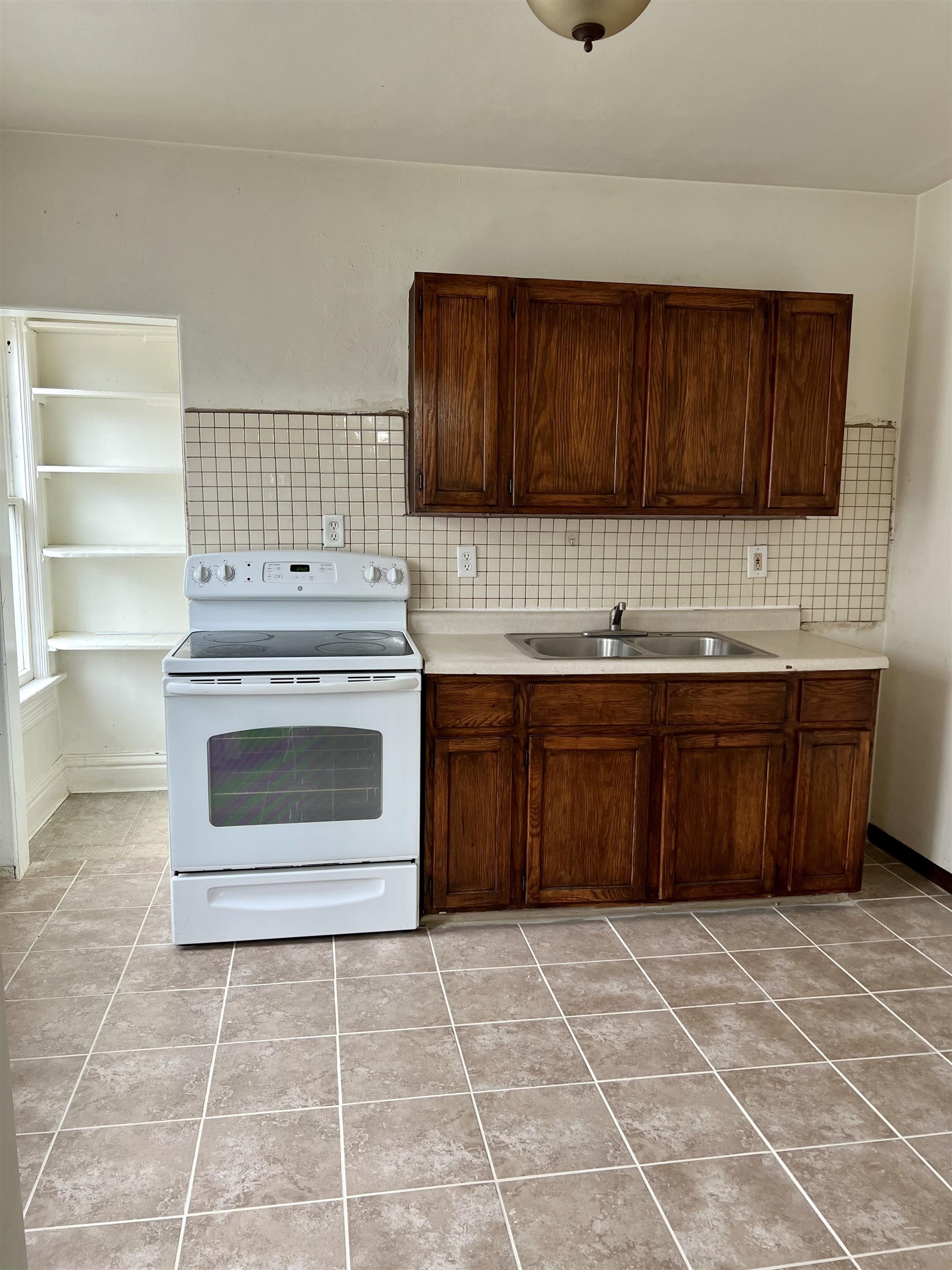 417 9th Street Rockford, IL 61104 - Photo 9 of 11 a kitchen with a cabinets and a stove top oven