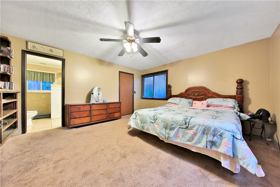 75072 Edwards Road Yulee, FL 32097 - Photo 13 of 27 a bedroom with a bed and a chandelier