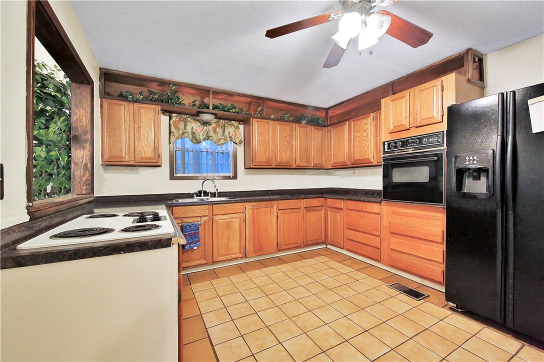 75072 Edwards Road Yulee, FL 32097 - Photo 3 of 27 a kitchen with stainless steel appliances granite countertop a refrigerator a sink dishwasher a stove and white countertops with wooden floor