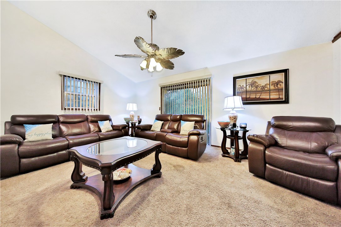 75072 Edwards Road Yulee, FL 32097 - Photo 8 of 27 a living room with furniture a chandelier and a window