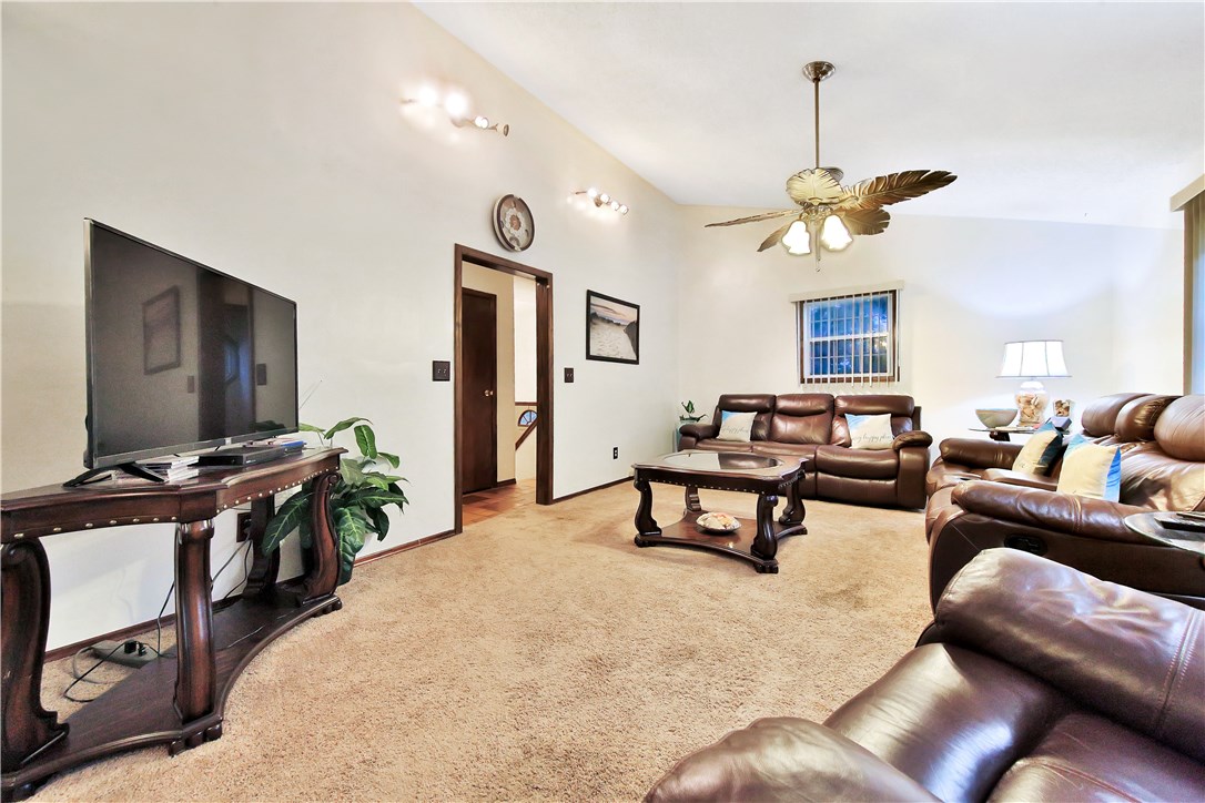 75072 Edwards Road Yulee, FL 32097 - Photo 9 of 27 a living room with furniture a chandelier and a flat screen tv