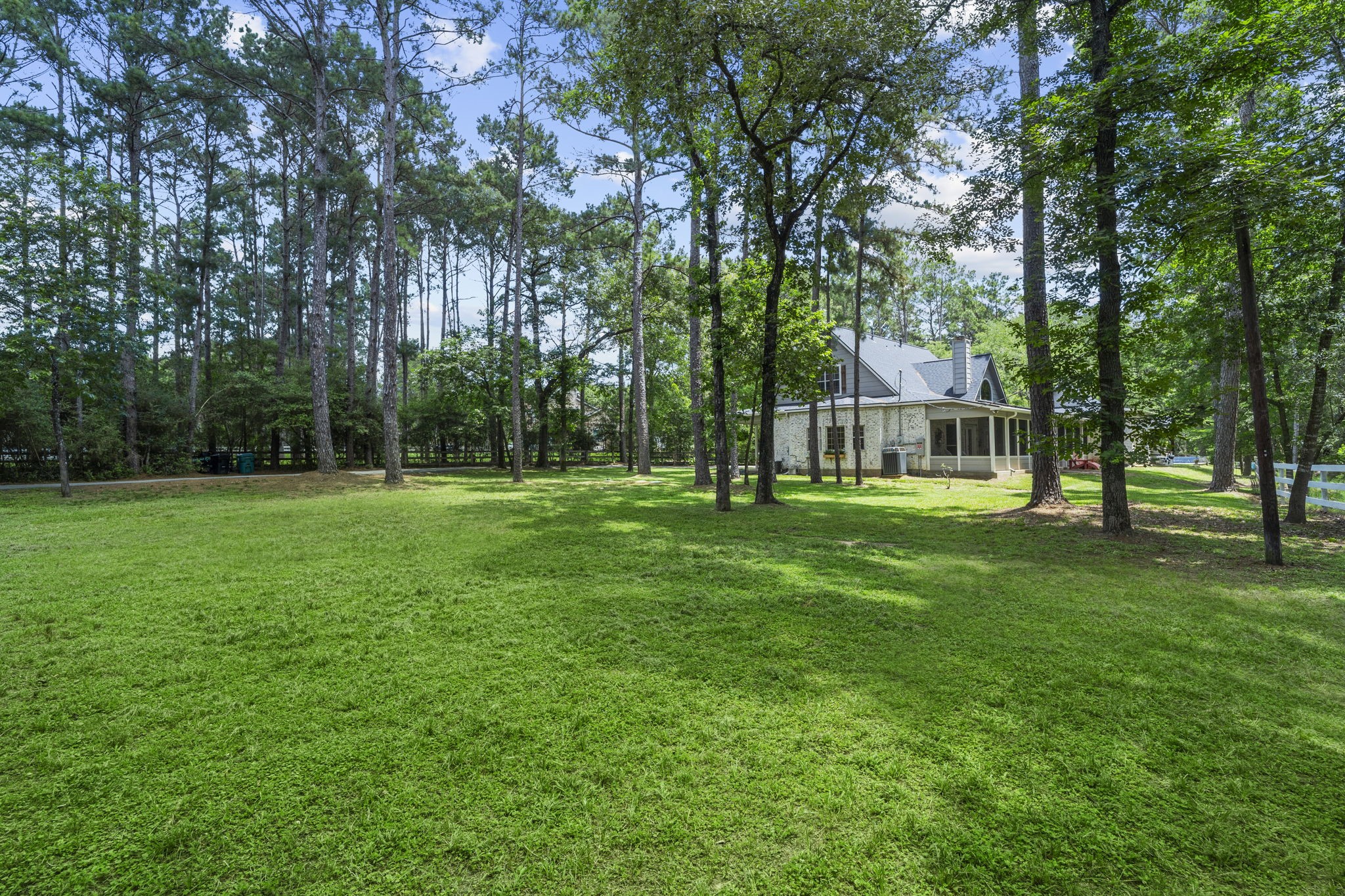 19610 Timber Ridge Drive Magnolia, TX 77355 - Photo 33 of 50 From the front yard looking back toward the home, this view showcases the peaceful setting of the property. This view shows the back of the home which faces the east side of the property.