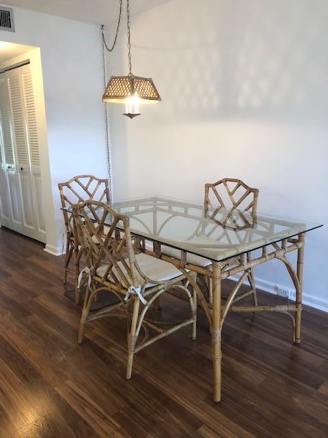 1044 Rexford Drive Boca Raton, FL 33434 - Photo 11 of 50 a view of a dining room with furniture and wooden floor