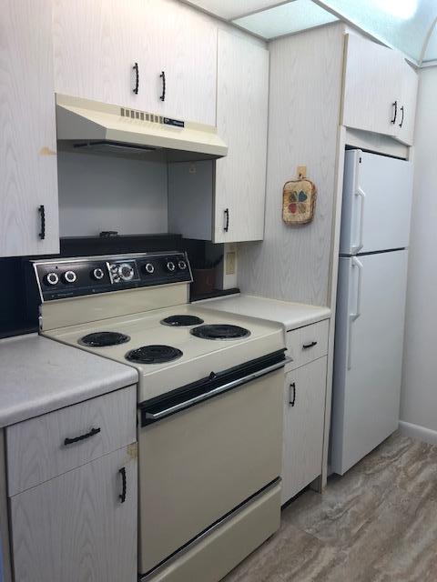 1044 Rexford Drive Boca Raton, FL 33434 - Photo 12 of 50 a kitchen with a stove and a refrigerator