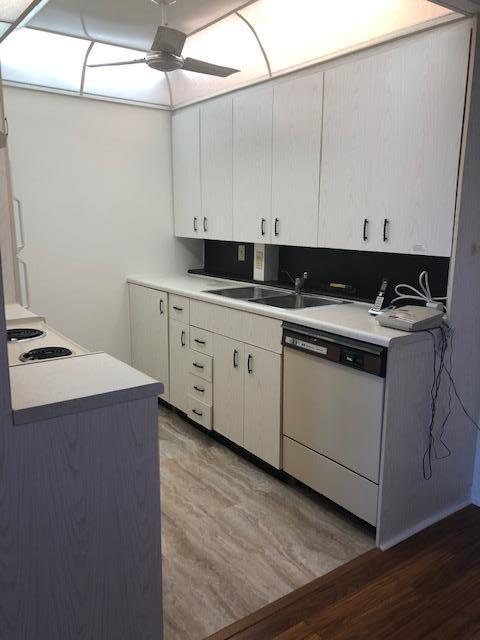1044 Rexford Drive Boca Raton, FL 33434 - Photo 16 of 50 a kitchen with a sink cabinets and wooden floor