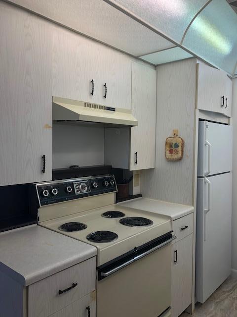 1044 Rexford Drive Boca Raton, FL 33434 - Photo 17 of 50 a white stove top oven sitting inside of a kitchen