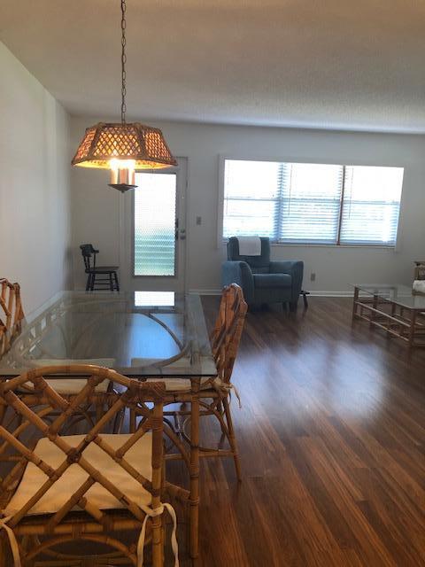 1044 Rexford Drive Boca Raton, FL 33434 - Photo 18 of 50 a view of a dining room with furniture window and wooden floor