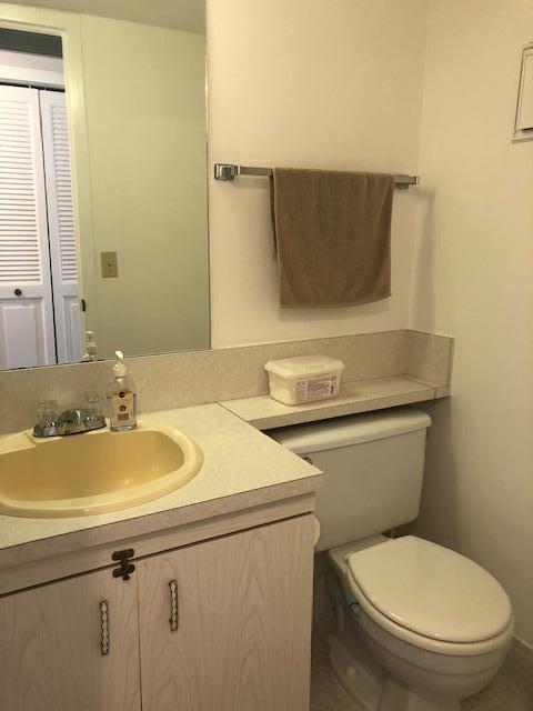1044 Rexford Drive Boca Raton, FL 33434 - Photo 20 of 50 a bathroom with a granite countertop toilet sink and mirror
