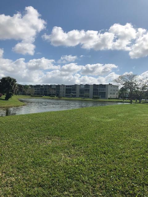 1044 Rexford Drive Boca Raton, FL 33434 - Photo 3 of 50 a view of a lake with a big yard