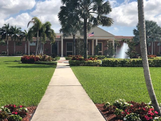 1044 Rexford Drive Boca Raton, FL 33434 - Photo 36 of 50 a front view of house with garden