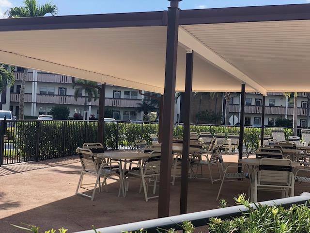 1044 Rexford Drive Boca Raton, FL 33434 - Photo 43 of 50 a patio with table and chairs