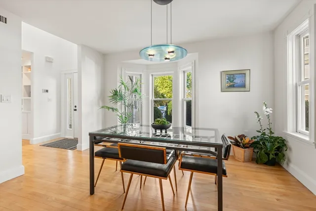 a spacious bedroom with a bed chandelier and a window