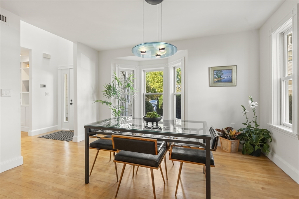 169 Walnut Street, Unit 2 Boston, MA 02122 - Photo 12 of 42 a view of a dining room with furniture window and wooden floor